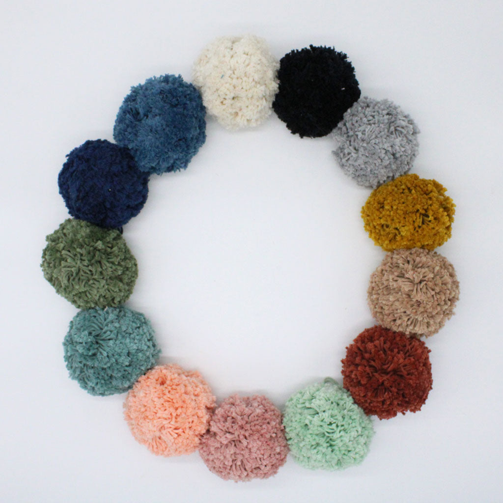 Jojo boho handwoven baby changing basket  pompom colours