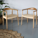 A pair of Maya Ash Wood Dining Chairs