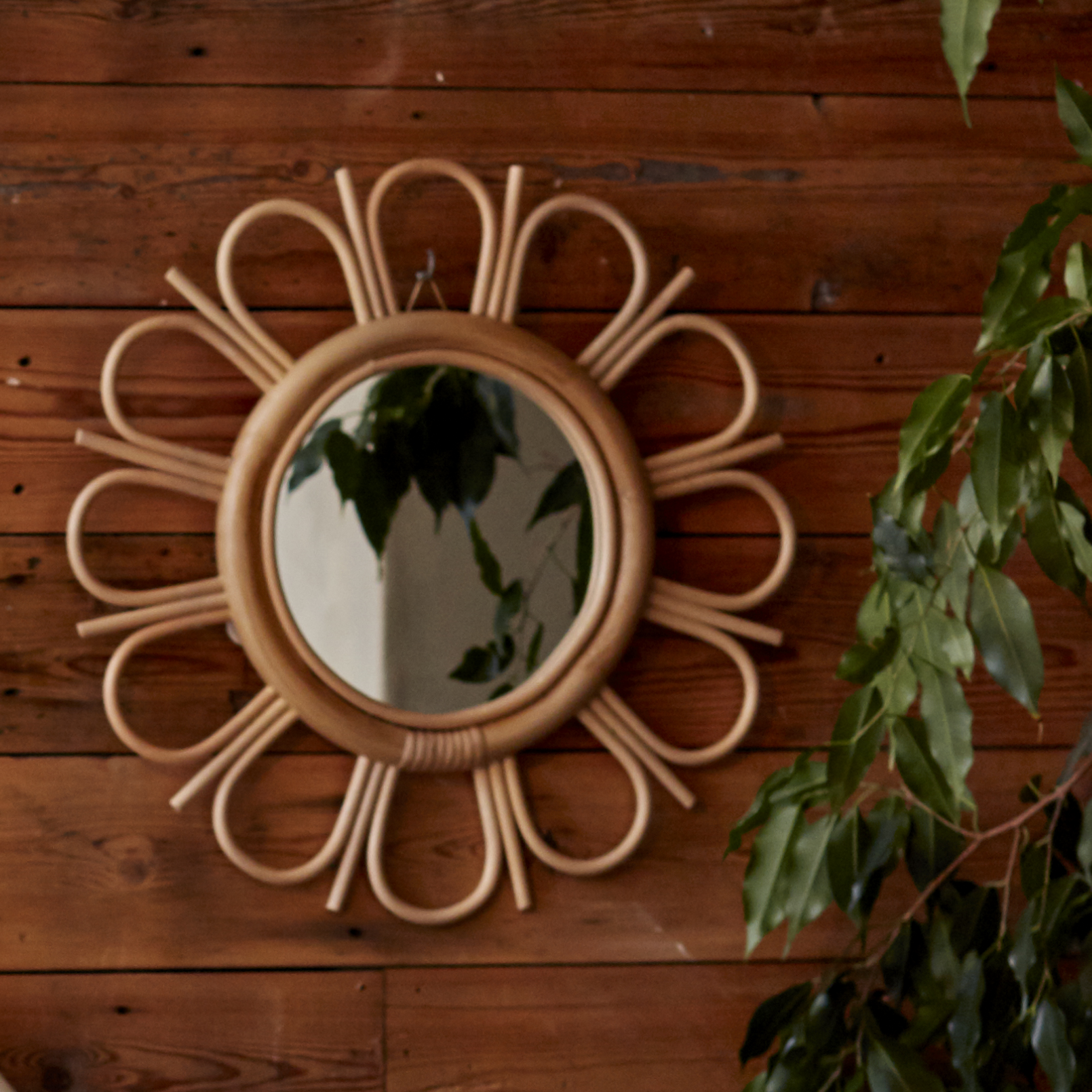 Natural Rattan Sunflower Mirror against Wood Wall- The Rattan Company